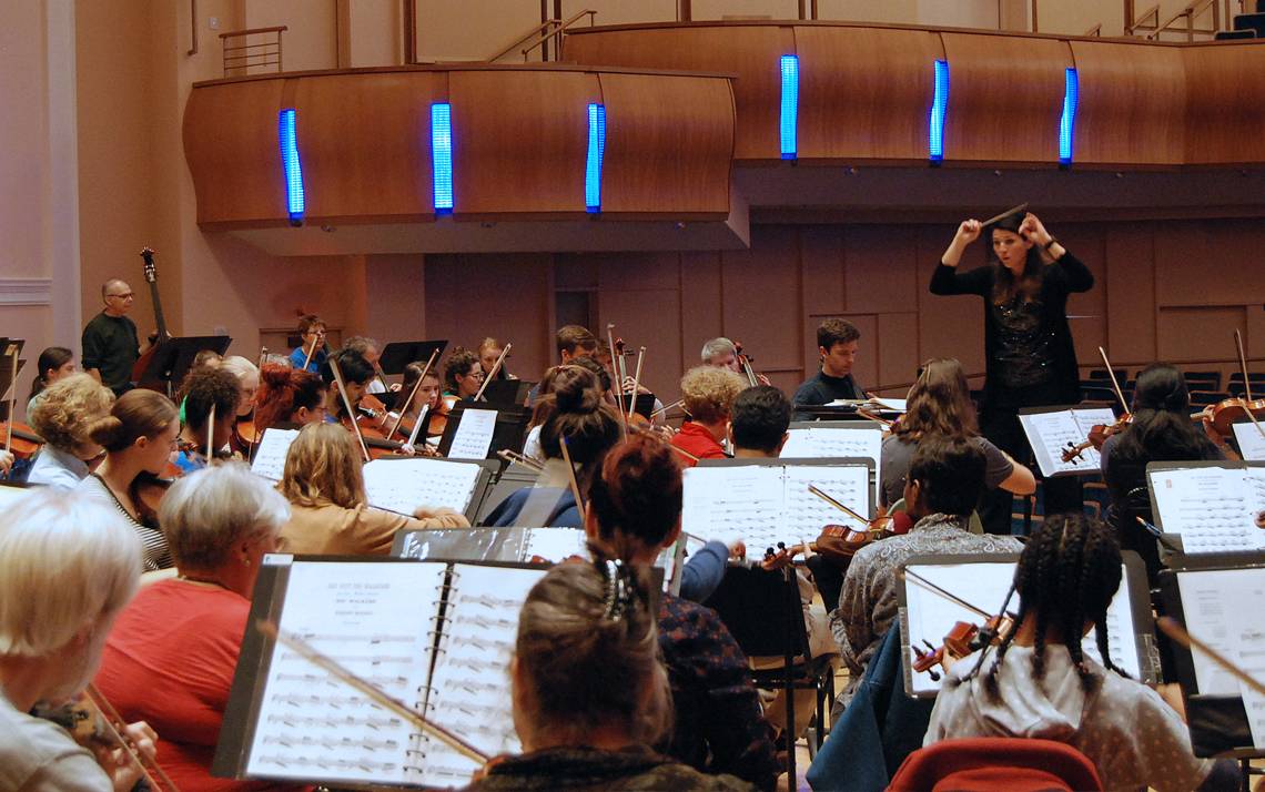 Verena Mösenbichler-Bryant, the Durham Medical Orchestra's conductor and artistic director, leads a rehearsal.