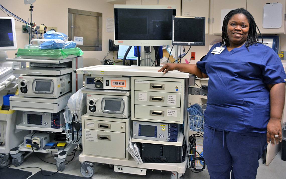 Emma Townsend starts her day by setting up a mobile cart for the day’s operations, anything from colonoscopies to examinations of the esophagus and intestines. Photo by Jonathan Black.