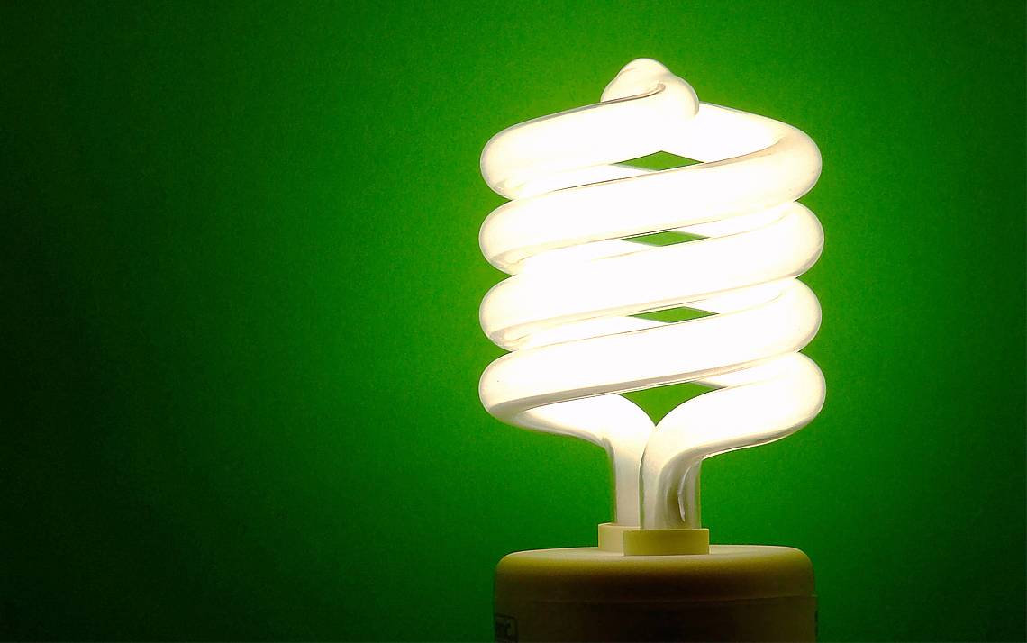 A lightbulb against a green backdrop.