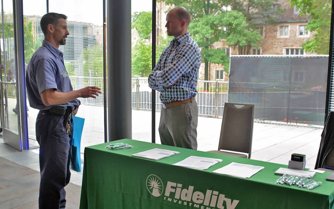 Duke staffer Rick Teta, left, talks with Fidelity retirement planner Alan Collins at Duke Financial Fitness Week.