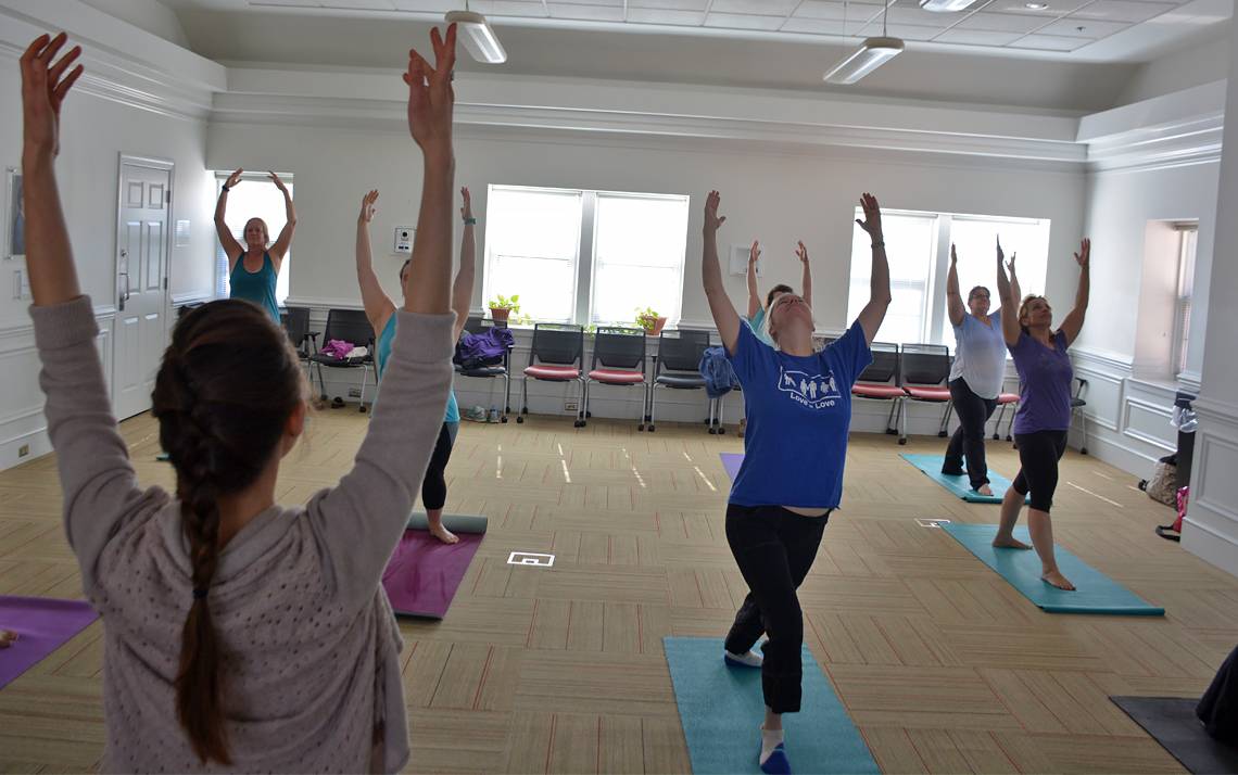 Employees at the John Hope Franklin Center attend a weekly yoga class.