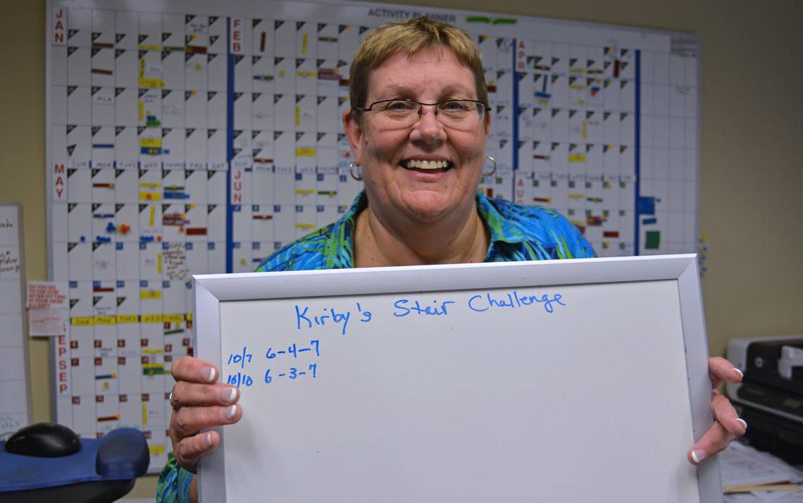 Duke administrative assistant Kirby Forbes tallies the flights of stairs she walks on a whiteboard in her office.