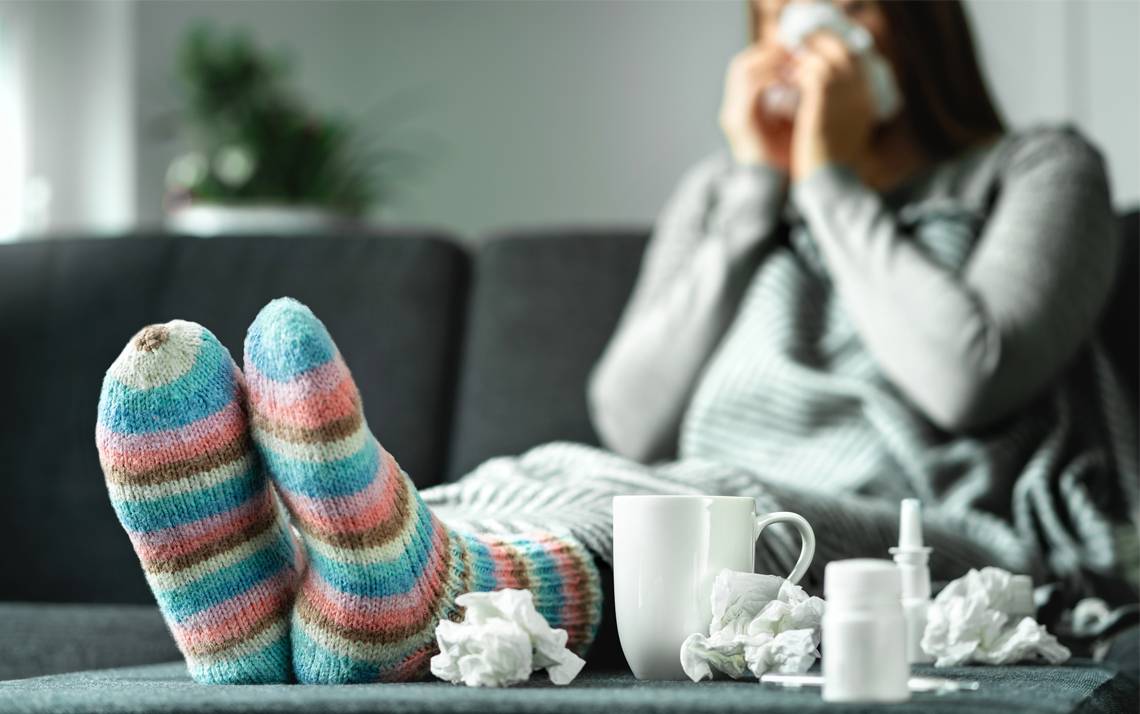 A sick person sitting on a couch.