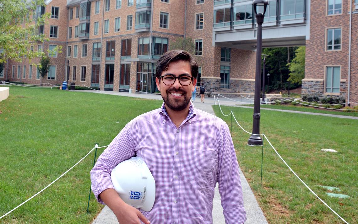 Hector Hernandez stands in front of the Hollows Quad. Hernandez oversaw the construction of the 265,000 square-foot facility. Photo by Jonathan Black.