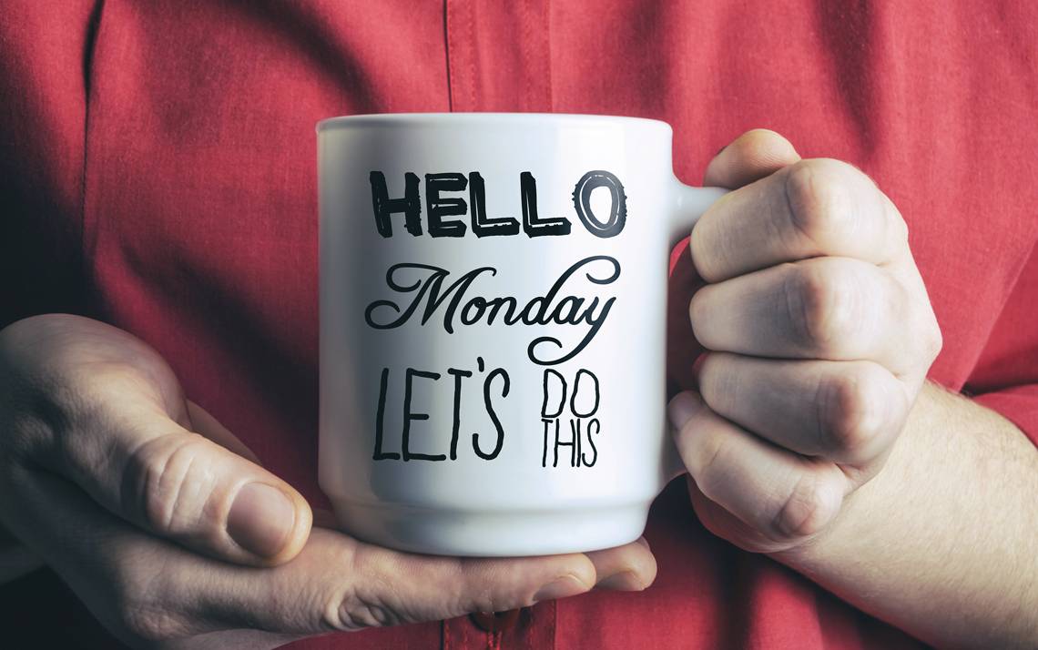 Hands holding a coffee mug.