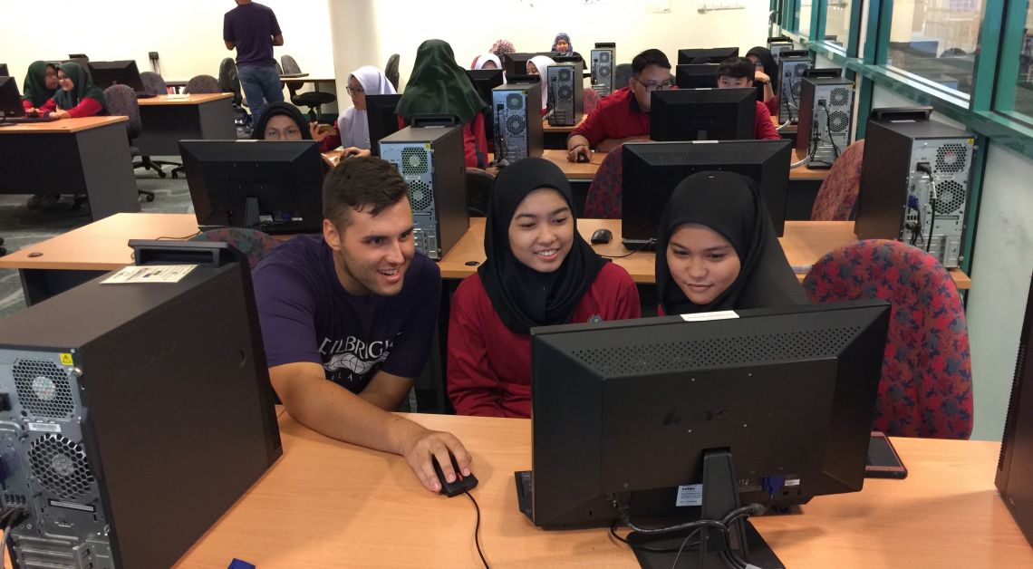 Jay Sullivan ‘16 (left), a Fulbright English Teaching Assistant in Malaysia, surrounded by students.