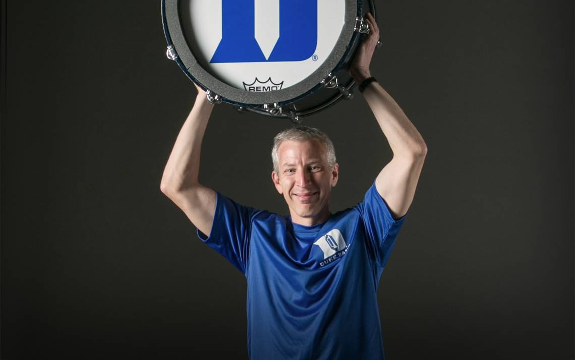 Jeff Au, director of the Duke University Marching & Pep Band, lifts weights and runs on campus.