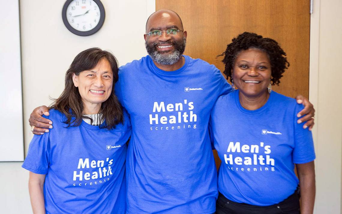 Three people in blue shirts.