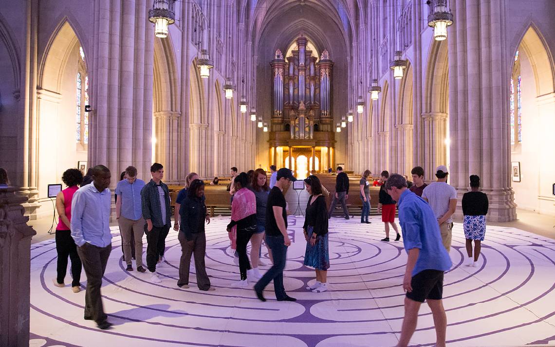 Duke community members take part in the labyrinth walk in the Duke Chapel. The self-guided walk is an ancient spiritual practice of meditation and self-centering found in religious traditions from around the world.