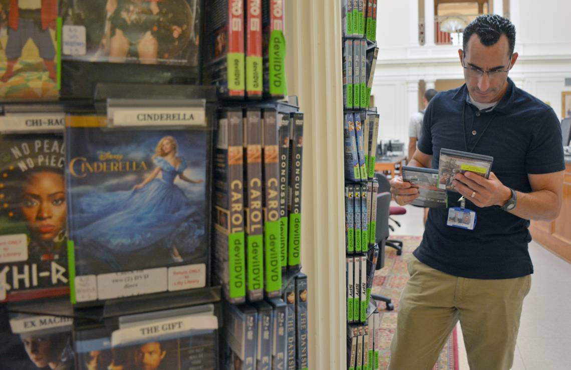 Duke photographer Jared Lazarus peruses the selection of DVDs at Lilly Library on East Campus.