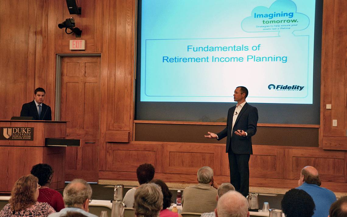 Kyle Jaquez, left, and Sonny Bowser, right, talk to Financial Fitness Week participants about saving for retirement. Photo by Jonathan Black.