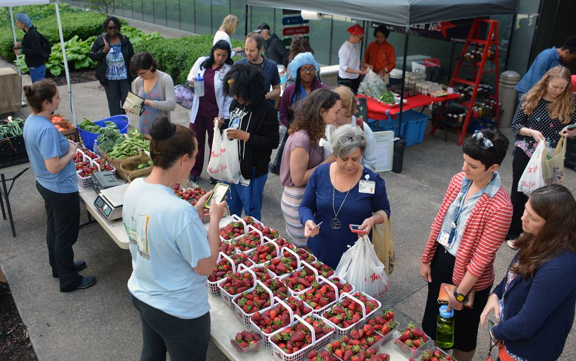 Employees shop for fresh strawberries, bread and empanadas