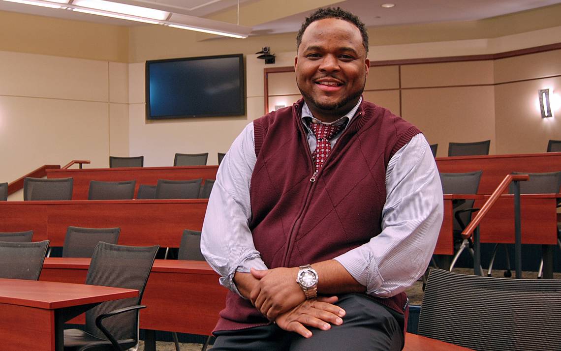 Michael Cary, associate professor at the Duke University School of Nursing, sits in the classroom where he gave his first lecture as a Duke faculty member. Photo by Stephen Schramm.