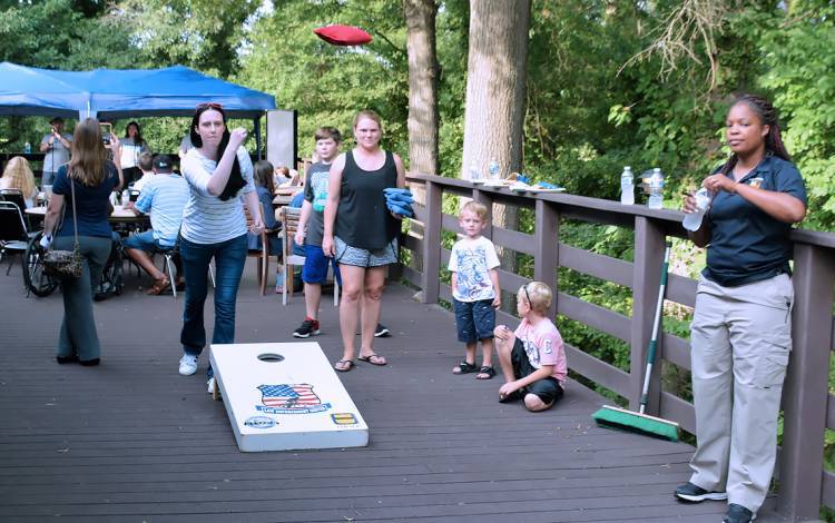 Ann Hale, a financial care counselor with Duke's Durham Gastroenterology Consultants and an alumna of Duke’s Citizens’ Police Academy, plays cornhole during last year's National Night Out event.