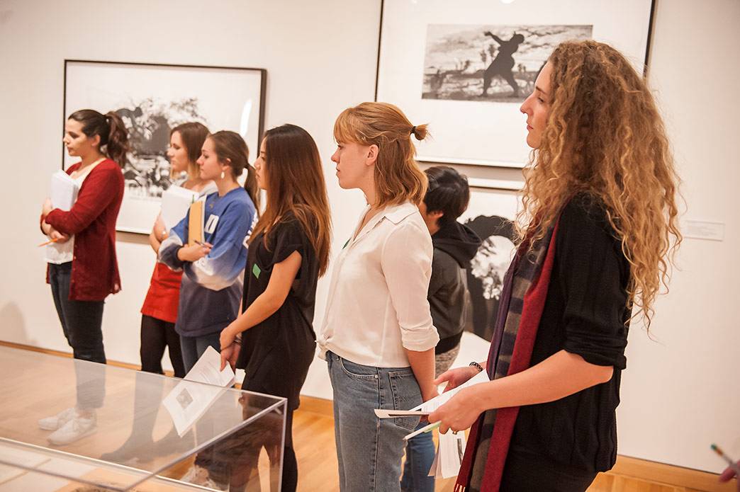 Duke students in the Museum Theory and Practice class listen as Nasher Museum Director Sarah Schroth talks about prints by Kara Walker that are part of the museum’s collection. Photo by J Caldwell