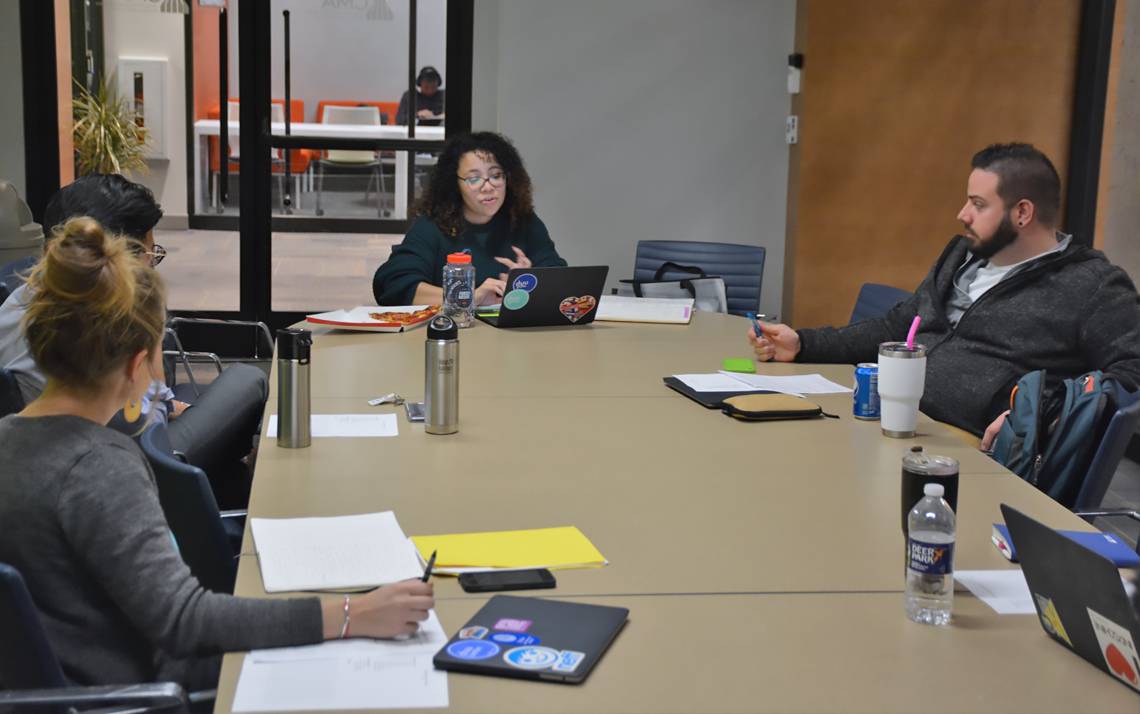 Francesqa Santos, center, a new employee with Duke Student Affairs' Student Involvement team, speaks during a staff meeting. Photo by Jonathan Black.