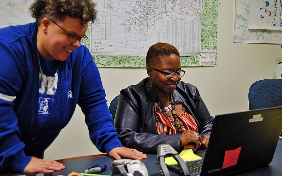 Duke Disability System's Ashley Robbins, left, works with Marquita Mangum of the Foundational Skills Program. Photo by Stephen Schramm.