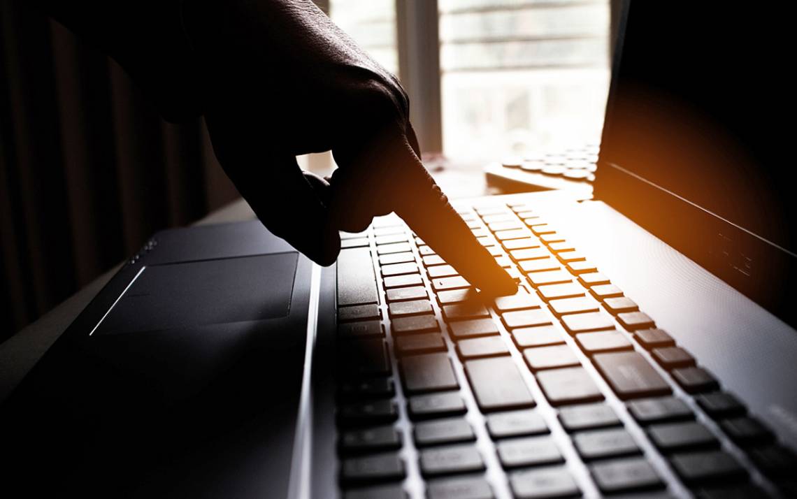 A hand using a keyboard.