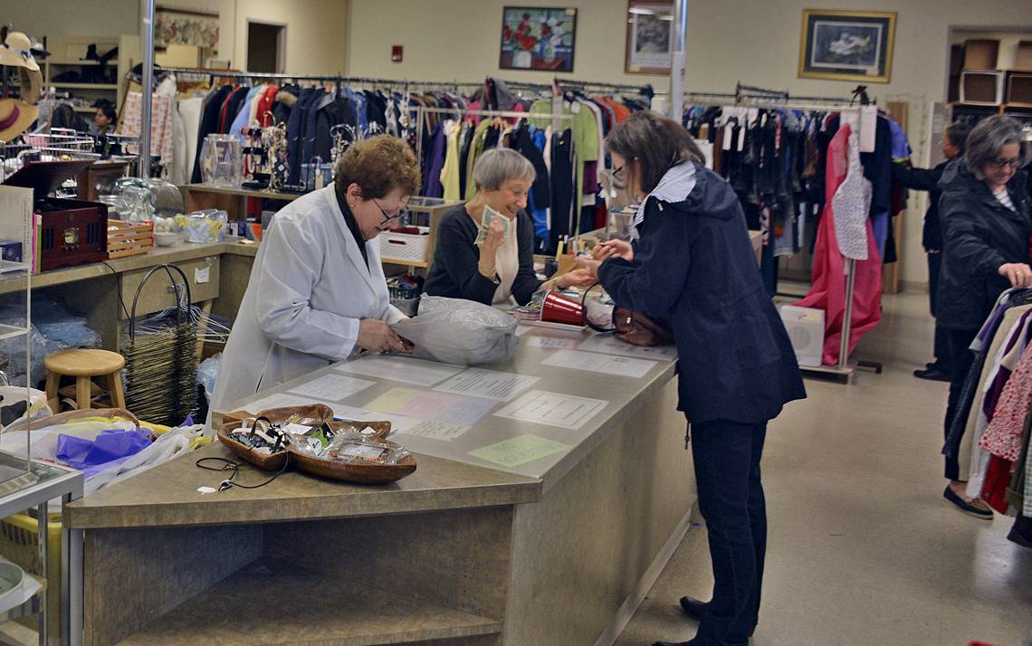 Katherine Halpern (left) and Ginny Lang (right) work the check out desk at the Nearly New Shoppe.