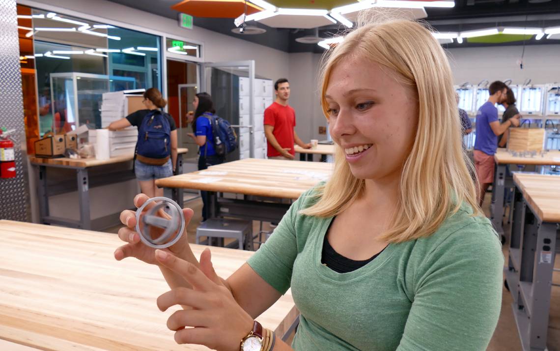 Student Kris Elbert shows off a 3D print creation at the Technology Engagement Center.