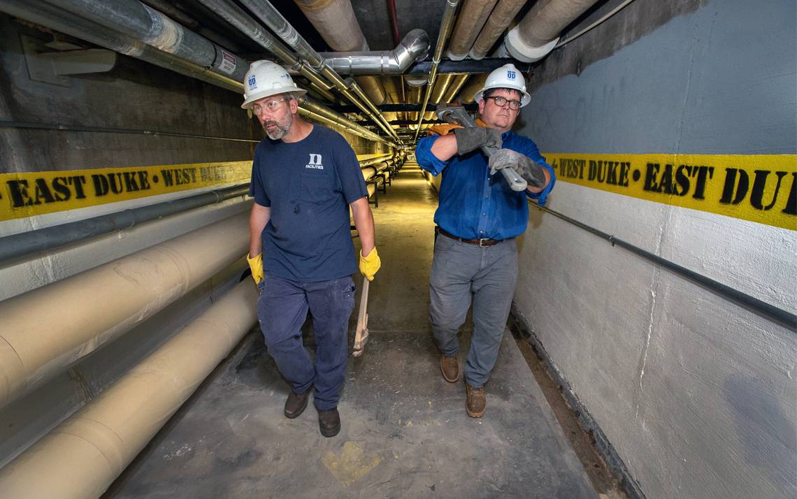 Tim Duggan, left, and Yancey Leonard, right, walk in the tunnel underneath East Campus. Photos by Chris Hildreth.