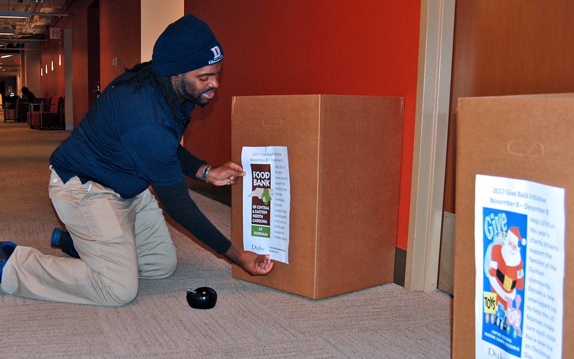 Facilities Management Department staff member Wayne Oatis sets up a donation box in Perkins Library.