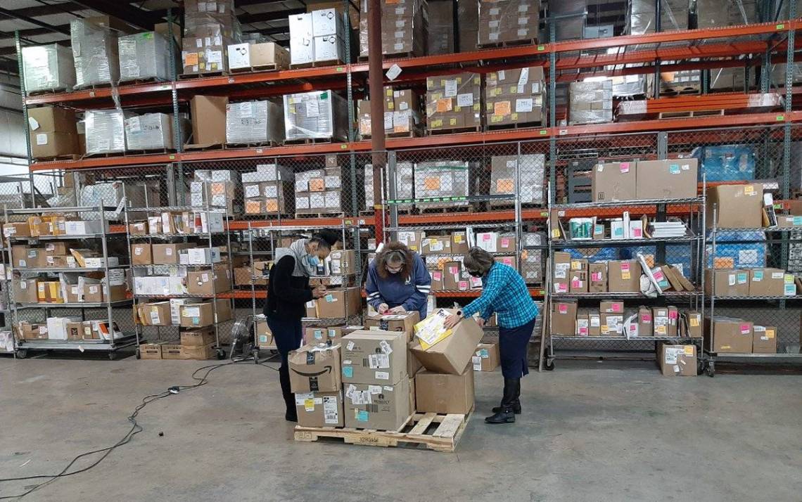 Left to right: Duke Procurement and Supply Chain Management team members Ajia Veras, Donna Neal and Tonya Oakley sort packages meant for Duke's campus. Photos courtesy of Mary Crawford.