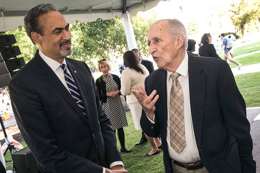 At a 2016 ceremony, Phil Freelon, left, talks with Julian Abele Jr., son of the architect who designed much of West Campus.