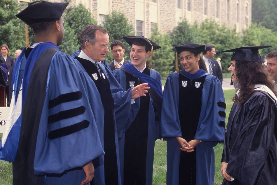 George H.W. Bush talks with students following the 1998 commencement ceremony. Photo courtesy University Archives.