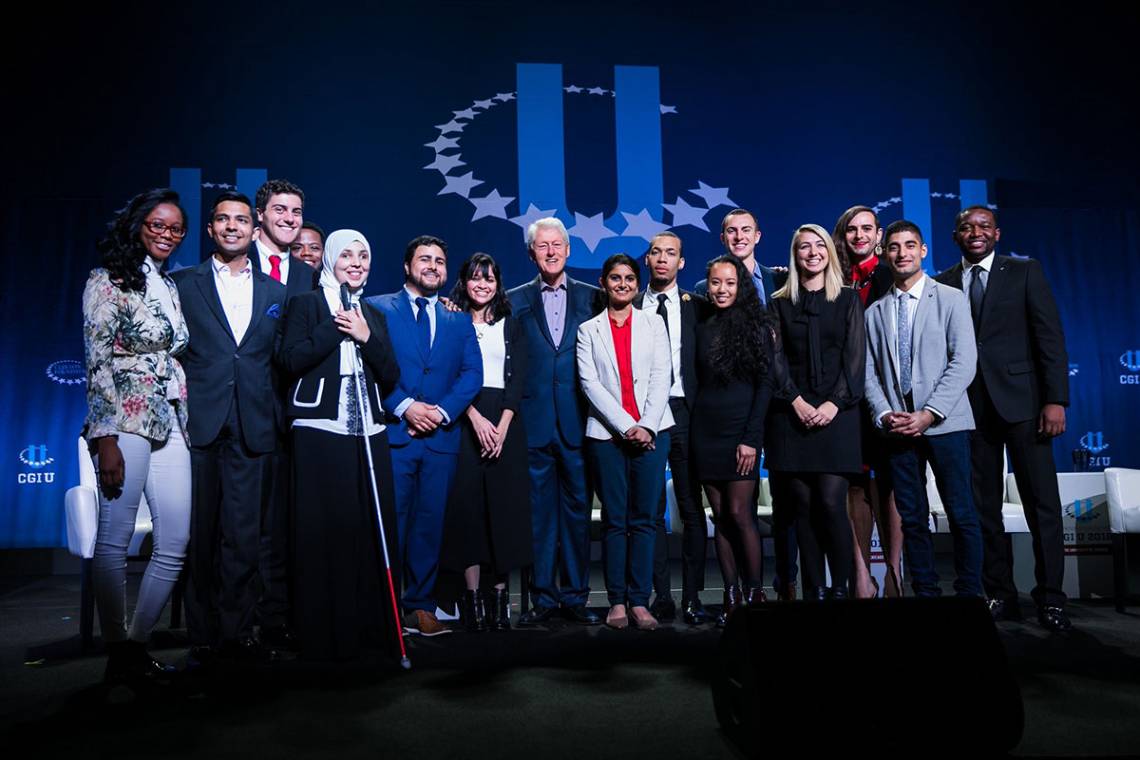 Fifteen CGI U Honor Roll individuals join Bill Clinton on stage. Three were alums from Duke. One is a recent Duke alumnus who already has helped make progress for the LGBTQ community across the nation. One is helping to break the glass ceiling for women i