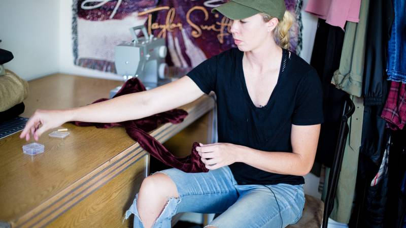 Erin Mathias plans fashions at her work desk. Photo by Pilar Timpane