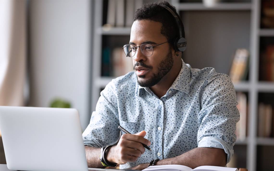 A man works at a computer.