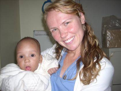 Duke nursing student Rebecca Carson with a young patient in Tanzania.