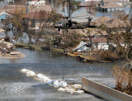 A Texas Army National Guard Blackhawk deposits a 6,000 pound-plus bag of sand and gravel to help close the breach in the 17th Street Canal in New Orleans following Hurricane Katrina in 2005. Photo Courtesy WIkimedia Commons