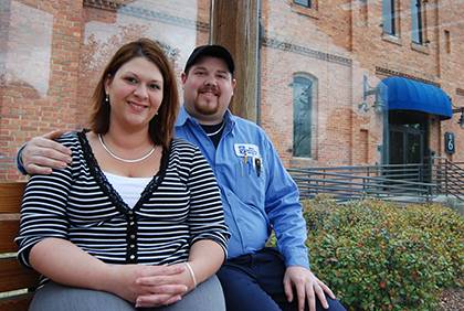 Ashley and John Glenn sit outside Duke's Smith Warehouse, where they both work. Photo by Bryan Roth.
