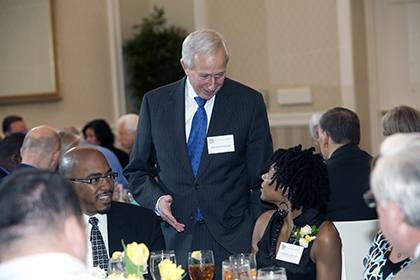 President Richard H. Brodhead chats with LaMonica Hunter, a Meritorious Service Award winner, at the Presidential Award Luncheon in 2012. Photo by Duke Photography.