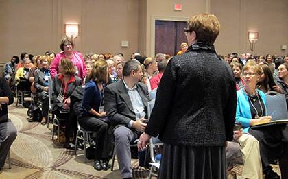 Kae Greenleaf, in pink, and other grant managers with more than 30 years experience were recognized by Julie Cole, in grey, at this year's Symposium for Research Administrators. Photo by Marsha A. Green