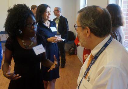 Bioethics and Science Policy masters degree candidate Nana Young (left) chats with faculty member Phil Rosoff M.D., director of clinical ethics at Duke Hospital, during an introductory mixer for the program. Science & Society director Nita Farahany stand