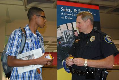 Jordan DeLoatch , left, a first-year student at Duke, talks safety with Eric Hester, crime prevention officer with the Duke University Police Department, during a