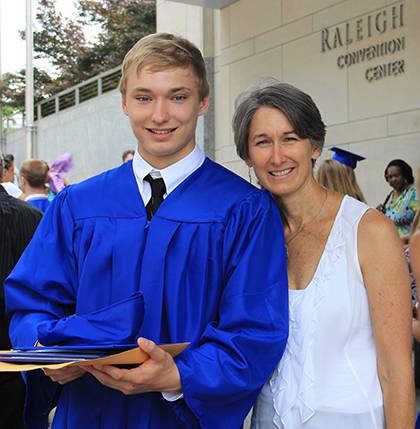 Irene Jasper, Duke Financial Aid's director of student lending, poses with her son, Alex, at his high school graduation ceremony in June. They both attended Duke's 