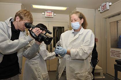 Chris Smith, education specialist at the Duke Lemur Center, video tapes a baby lemur. It's just one of his many job responsibilities at the Center that keep him invested in work and motivated. Photo courtesy of Chris Smith.