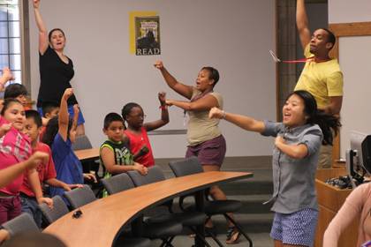 Students and teachers start the day off by pulling together in Harambee.  Photo by Jonathan Alexander.