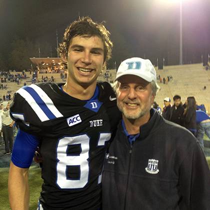 Dr. Anthony Galanos, Duke's honorary employee captain for the Aug. 30 football game, poses with Blue Devils wide receiver Max McCaffrey after a home game. Galanos wanted a picture with him because McCaffrey wears #87, the same number Galanos wore for his