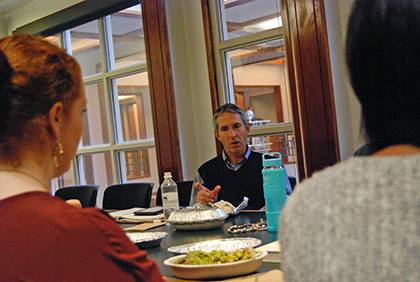 Jim Gudaitis, director of advancement services with Sanford School of Public Policy’s Development and Alumni Relations office, speaks with colleagues during a recent book club meeting. Photo by Bryan Roth.