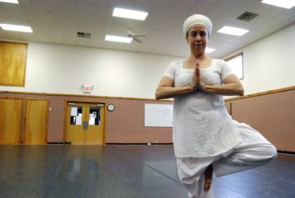 Keval Kaur Khalsa, strikes a yoga pose inside Duke's dance studio on Hull Avenue. Photo by Bryan Roth.