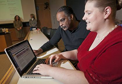 Christine Vucinich, training coordinator for Duke’s Office of Information Technology, looks over the lynda.com website with Alonzo Felder, an IT analyst at Duke. The self-learning website is one of many ways Duke offers professional development to facu