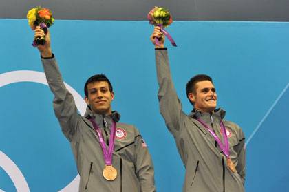 NIck McCrory, left, and David Boudia celebrate on the medal platform Monday. Photo by Christophe Simon/AFP/Getty Images