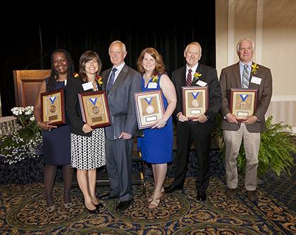 The 2012 Presidential Award winners gathered with President Brodhead after the award luncheon. From left: Cynthia P. Chavious, Julia A. Woodson, President Richard H. Brodhead, Susan L. Bonifield, Jonathan Giles and Paul D. Jones. Photo by Duke Photograph