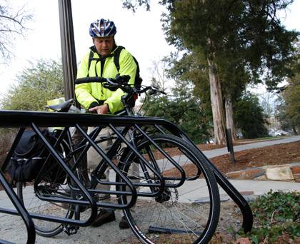 Steve Hinkle parks his bike at a rack next to Duke Chapel. Hinkle rides his bike to work every day. Photo by Bryan Roth.