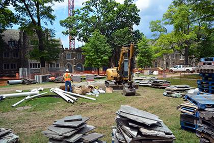 Construction is taking place this summer to remove bluestone sidewalks along the West Campus Quad in order to improve drainage and irrigation before replacing the same stone. Work will occur through August as the first phase of a three-year project. Phot